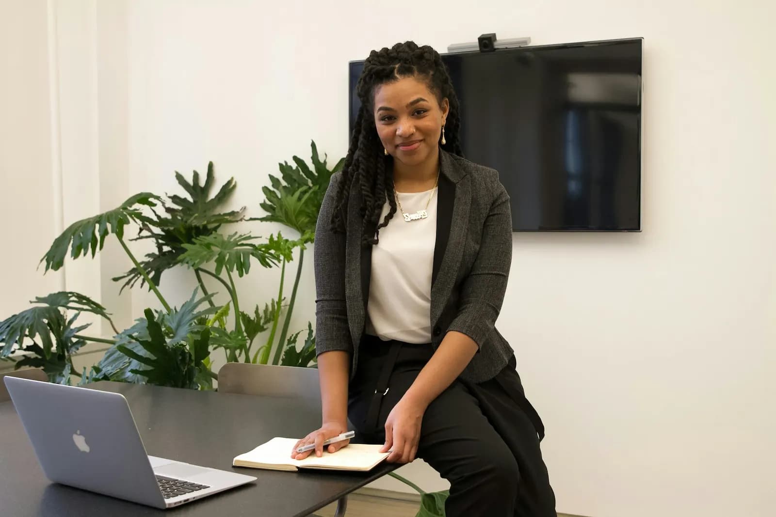 Woman working at a desk with a laptop
